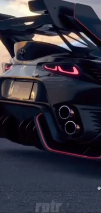 This black sports car phone live wallpaper captures the rear end of a dynamic vehicle, against a low sunset background