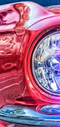 Looking for an eye-catching live wallpaper for your phone? Check out this close-up of a vivid red Mustang, featuring every attention-grabbing detail of its front end