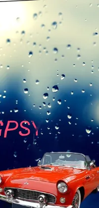 Rev up your phone's style with this live wallpaper featuring a dynamic picture of a red sports car speeding down a rain-soaked road