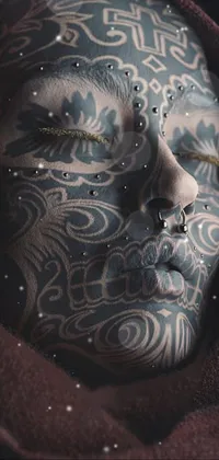 This phone live wallpaper features an incredible close-up of a person's face adorned with stunning tattoos