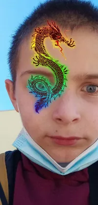This phone live wallpaper showcases a young boy with a mystical dragon painted on his face