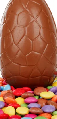 Indulge your sweet cravings with this delectable phone live wallpaper featuring a mouth-watering chocolate egg perched atop a colorful pile of candy