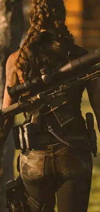 This unique phone live wallpaper showcases a realistic, full body close-up shot of a person holding a rifle and carrying survival gear