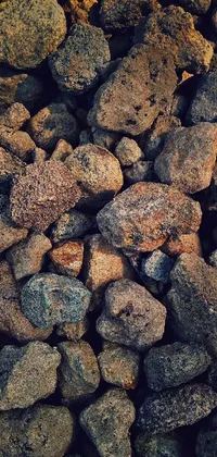 This live wallpaper features a stunning image depicting a pile of rocks with a volcanic texture, captured by a skilled photographer with an iPhone
