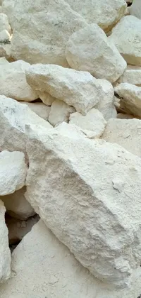 Enjoy a serene view on your phone with this live wallpaper featuring a pile of smooth white limestone rocks organized on a concrete surface in Agrigento, Italy