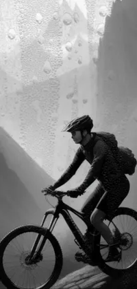 This live wallpaper showcases a mountain biker riding across a mountain peak