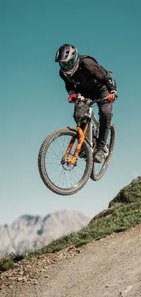 This Live Wallpaper features a bike rider flying through the air while carving his way through winding roads