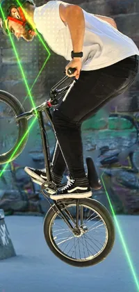 This bike-themed live phone wallpaper features an avatar of a man doing daring stunts on his bike