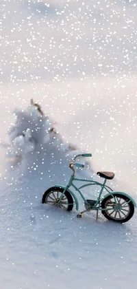 This live wallpaper depicts a realistic scene of a toy bike in a snowy setting