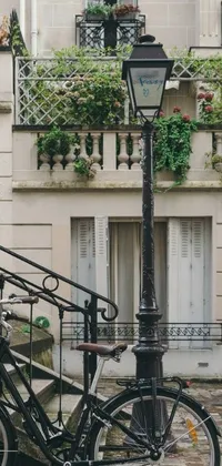 This phone live wallpaper showcases a vintage bicycle next to a Victorian-style lamppost in front of a building
