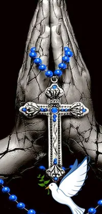 This live wallpaper displays a digital rendering of a hand holding a rosary and cross, with a serene blue and silver color scheme