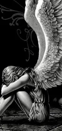This live phone wallpaper features a stunning black and white digital art of an angel sitting on a rock by Anne Stokes