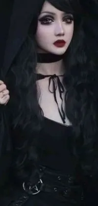 This phone live wallpaper features a gothic-inspired woman with long black hair, wearing a black hooded sweatshirt and a black camisole outfit