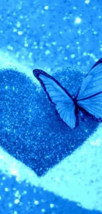 This phone live wallpaper depicts a striking scene of a butterfly perched on a glittery blue heart