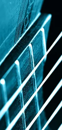 This blue toned phone live wallpaper displays a close-up image of the strings of a guitar
