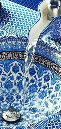This stunning phone live wallpaper features a beautiful blue and white sink with intricate mosaic patterns