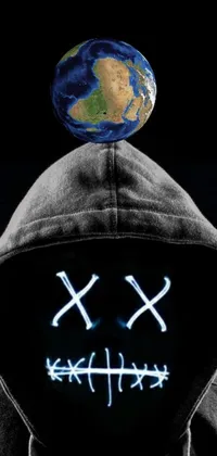 This phone live wallpaper showcases a visually stunning image of a hooded man carrying a globe on top of his head
