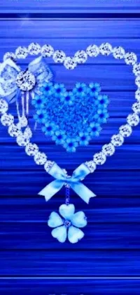 This exquisite phone live wallpaper features a charming and intricately designed heart on a serene blue background