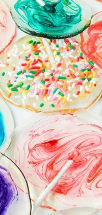 This phone live wallpaper features a delightful close up of a plate of cookies, decorated with yummy icing and sprinkles