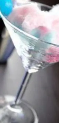 This phone live wallpaper features a mesmerizing martini glass filled with fluffy cotton candy