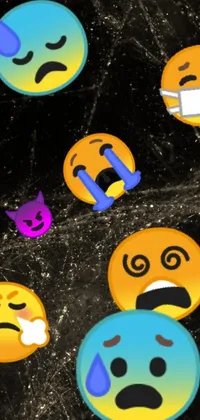 This live wallpaper features a cluster of emoticons that sit on a table in a digital art image, against a dark, smoky background
