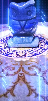 Experience the exotic beauty of the "Blue Owl on Marble Table" phone live wallpaper