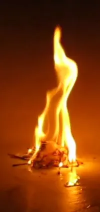 This live wallpaper features an up-close shot of a burning fire on a table in stunning high-resolution