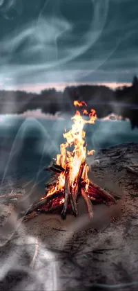 Experience the romance and mystery of a beach bonfire set against a beautiful body of water with our stunning live wallpaper