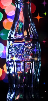 This phone live wallpaper features a stunning profile shot of a glass bottle on a table, with the Coca Cola brand logo visible on the label