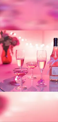 This live wallpaper features a still life of two wine glasses on a table against a romantic pink background
