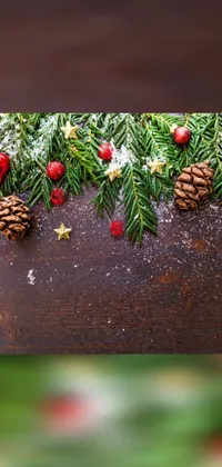 This phone live wallpaper features a beautiful wooden table adorned with pine cones and Christmas decorations