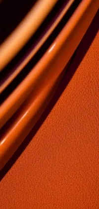 This phone wallpaper features a stunning stack of orange plates in a macro photograph with high details
