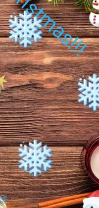 This phone live wallpaper features a festive wooden table adorned with Christmas decorations and glowing candles
