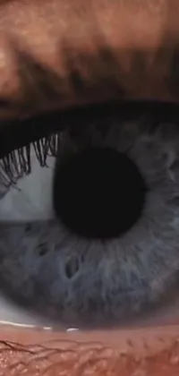 Get mesmerized by this stunning live wallpaper featuring a hyperrealistic close-up shot of a blue eye from a music video still