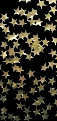 This live phone wallpaper showcases a stunning cluster of bronze stars against a black background