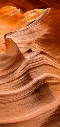 This phone live wallpaper features a mesmerizing close-up of a rock formation found in the desert of Antelope Canyon