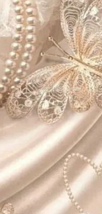 This incredible live wallpaper for your phone showcases a gorgeous butterfly perched on a baroque-style dress, complete in soft gold linens and beautifully crafted pearls