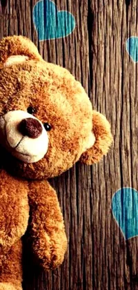 Looking for a cute and charming live wallpaper for your mobile phone? Check out our Teddy Bear Live Wallpaper featuring a cuddly teddy bear leaning against a wooden wall with an old-fashioned album cover in the background
