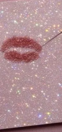 This phone live wallpaper features a close-up image of an envelope with a defined lipstick mark on it, against a reddish-brown colored background