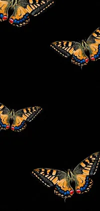 This gorgeous live wallpaper features a group of colorful butterflies resting on a sleek black surface