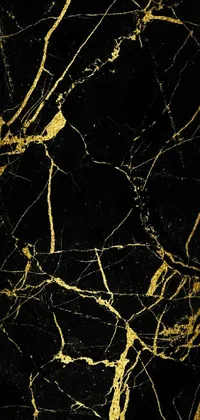 This phone live wallpaper features a stunning black and gold marble surface, complete with glowing cracks and wires
