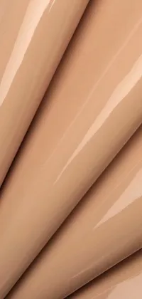This live wallpaper for your phone features a close-up of a beige plastic material with a tights skin-like texture and a glossy finish