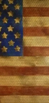 This phone live wallpaper depicts an American flag on a vintage table, adorned with a steampunk style for a unique, edgy look