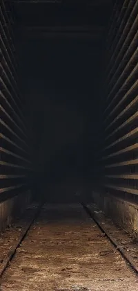Get captivated by this intriguing phone live wallpaper featuring a train track at the heart of a dark underground tunnel