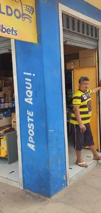 This vibrant phone live wallpaper showcases a man standing at the doorway of a colorful store boasting blue and yellow hues