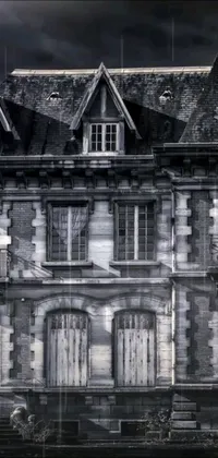This mobile live wallpaper features a stunning black-and-white photograph of a Gothic mansion by Michel Delacroix