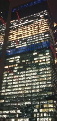 Enhance your phone's look with a stunning live wallpaper of a towering red and blue building at night