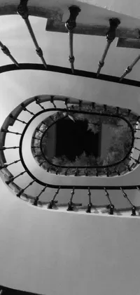This live wallpaper for phones showcases a black and white photo of a spiral staircase in an art nouveau style