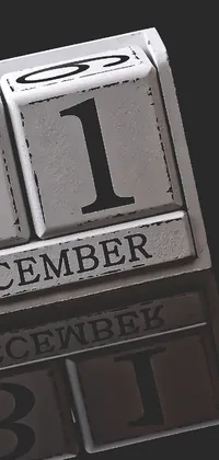 This phone live wallpaper showcases a stunning black and white photograph of a calendar