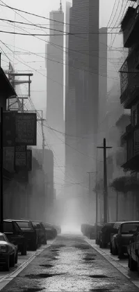 Transform your phone screen with this captivating live wallpaper of a black and white photograph that features a foggy street in a major city
